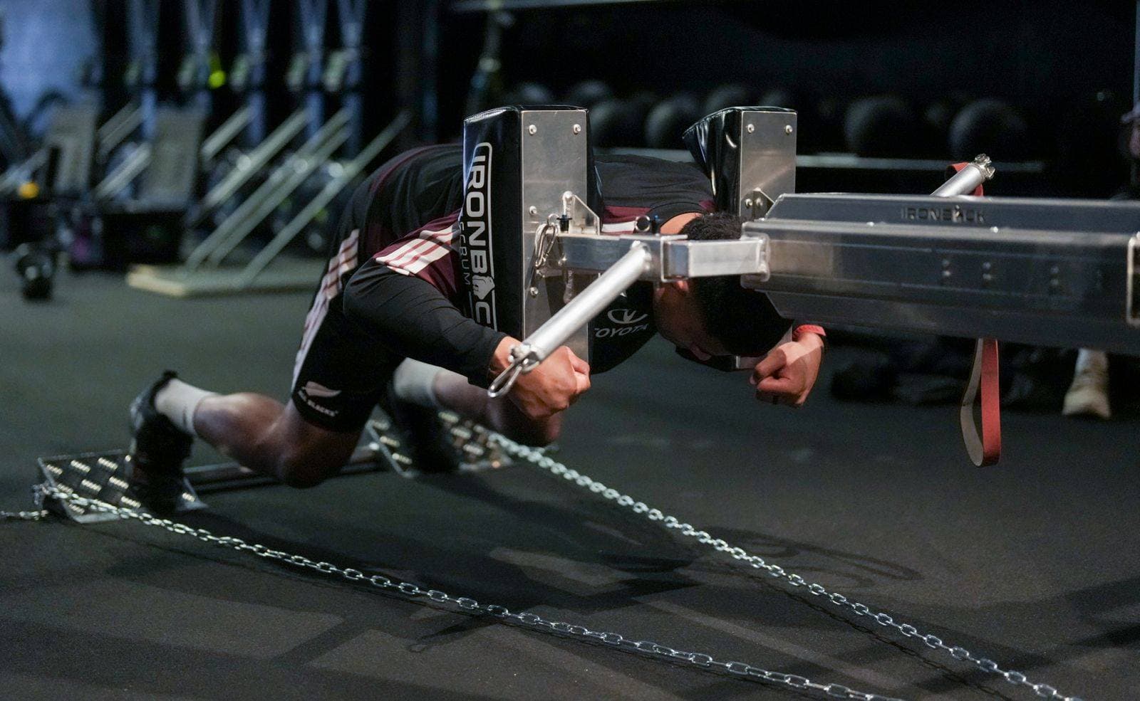 Athlete driving through an Ironback scrum training machine